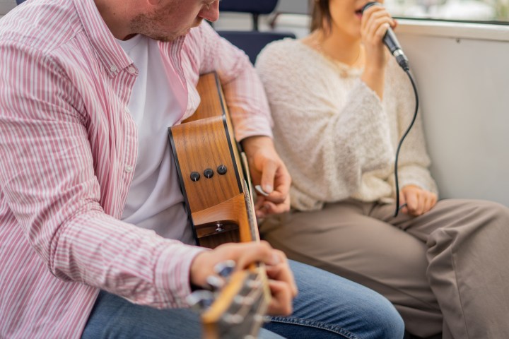 a man and a woman looking at her cell phone
