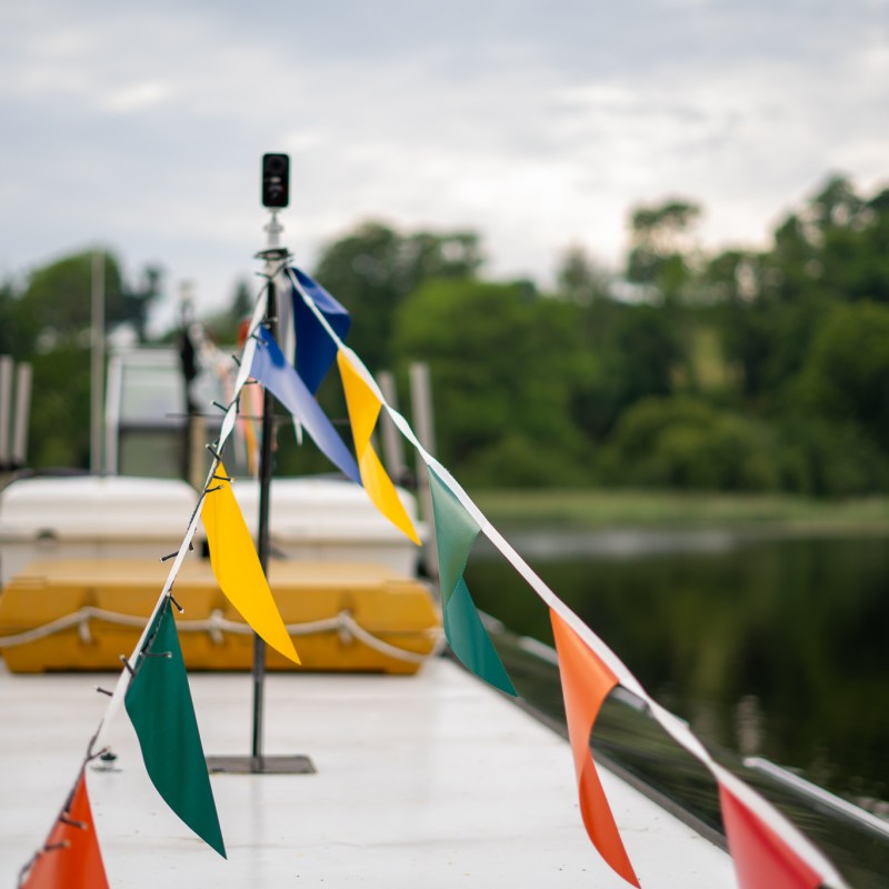 a person flying a kite in a boat on the water