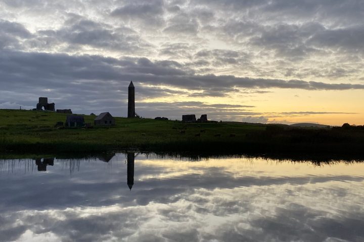 a group of clouds in the sky over a body of water